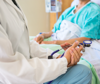 doctor talking to patient in hospital bed