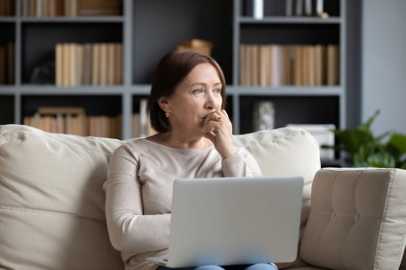 woman on laptop looking concerned