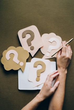 stock image of notebook and question mark